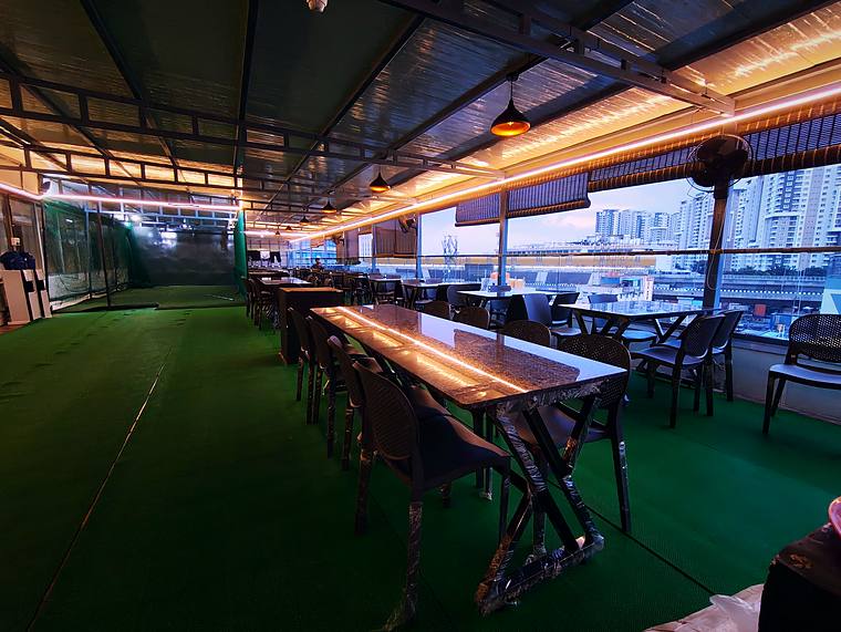 Rooftop dining lounge, afternoon light — Vaikuntum Elite Co-Living