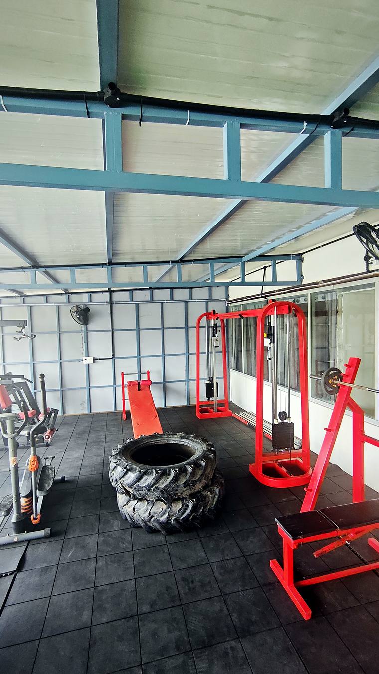 Free weights, kettlebells & training tyre in the rooftop gym — Vaikuntum Elite Co-Living