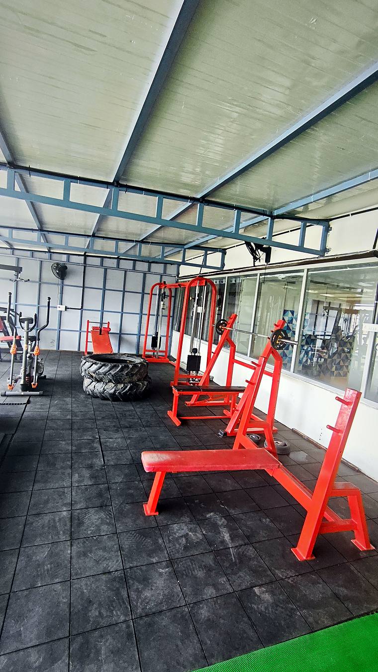 Bench press & racks in the rooftop gym — Vaikuntum Elite Co-Living
