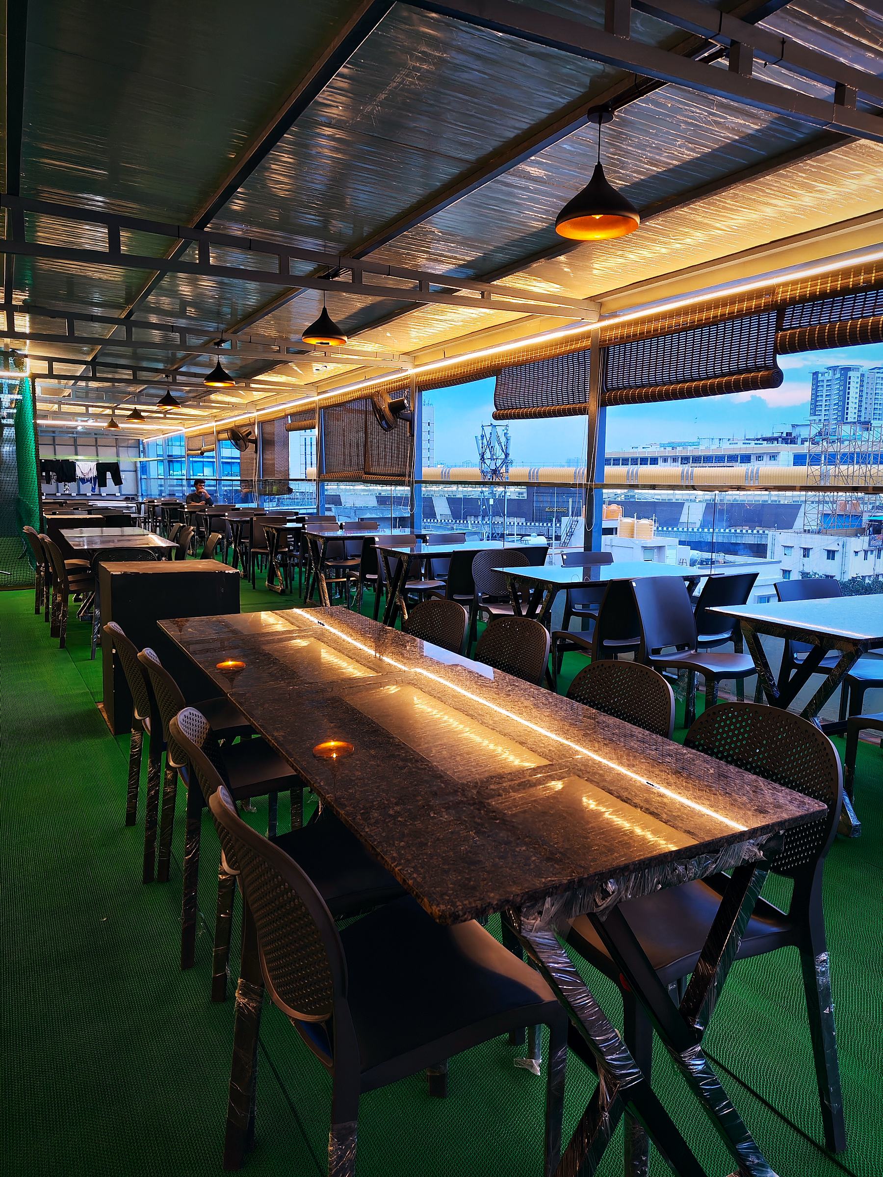 Enclosed terrace dining at dusk, Vaikuntum Elite Co-Living, Bommanahalli