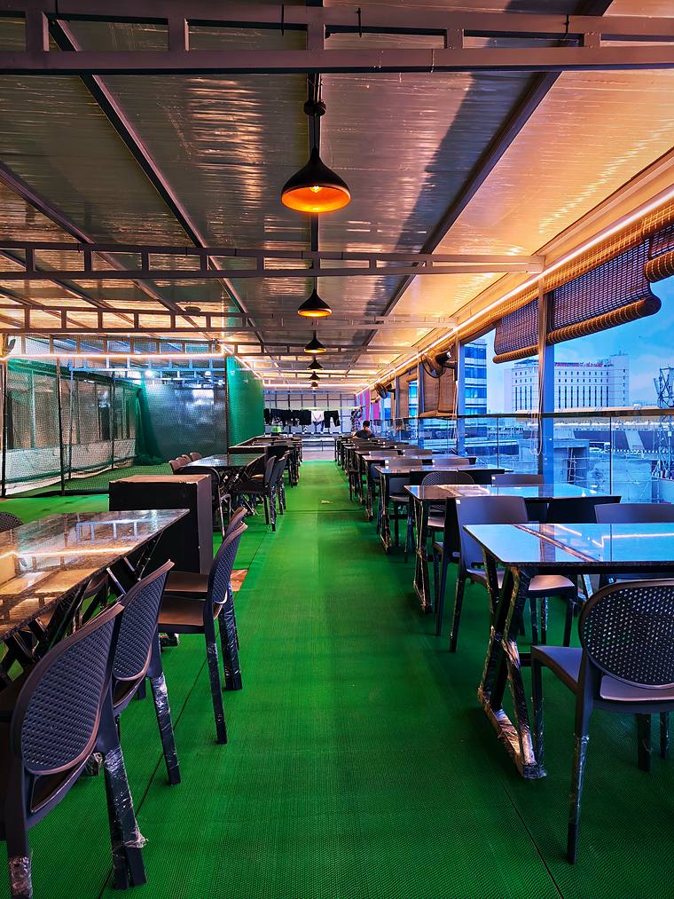 Rooftop café seating by day — Vaikuntum Elite Co-Living