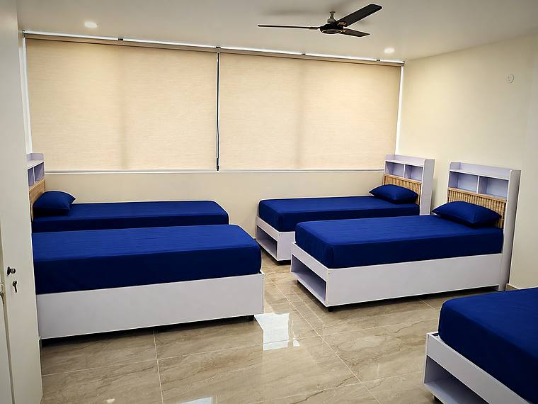 Sharing room, blue bedding — Vaikuntum Elite Co-Living