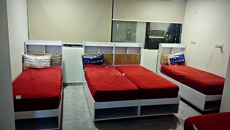 Sharing room, red bedding — Vaikuntum Elite Co-Living